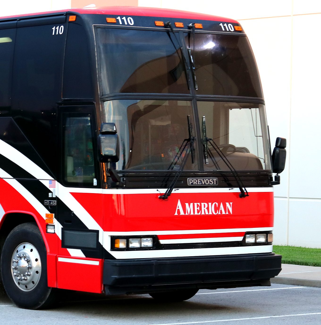 Front of American Coach motorcoach 110 with AMERICAN across the red nose