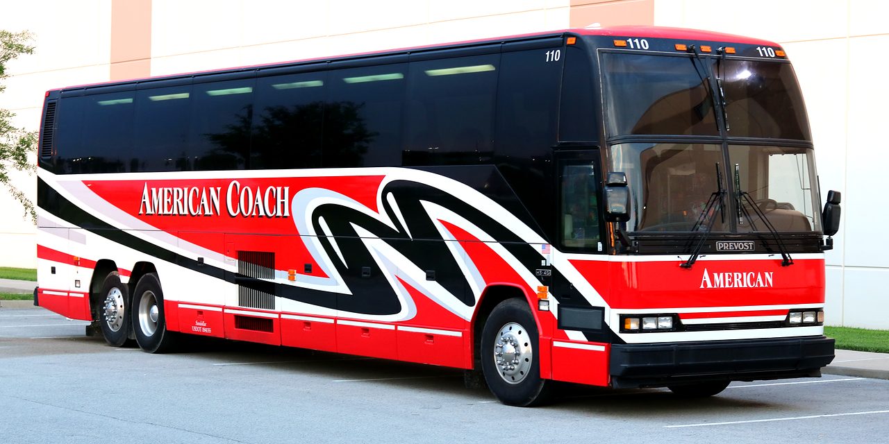 American Coach Travel motorcoach 110, a red, black and white Prevost coach parked in Louisville